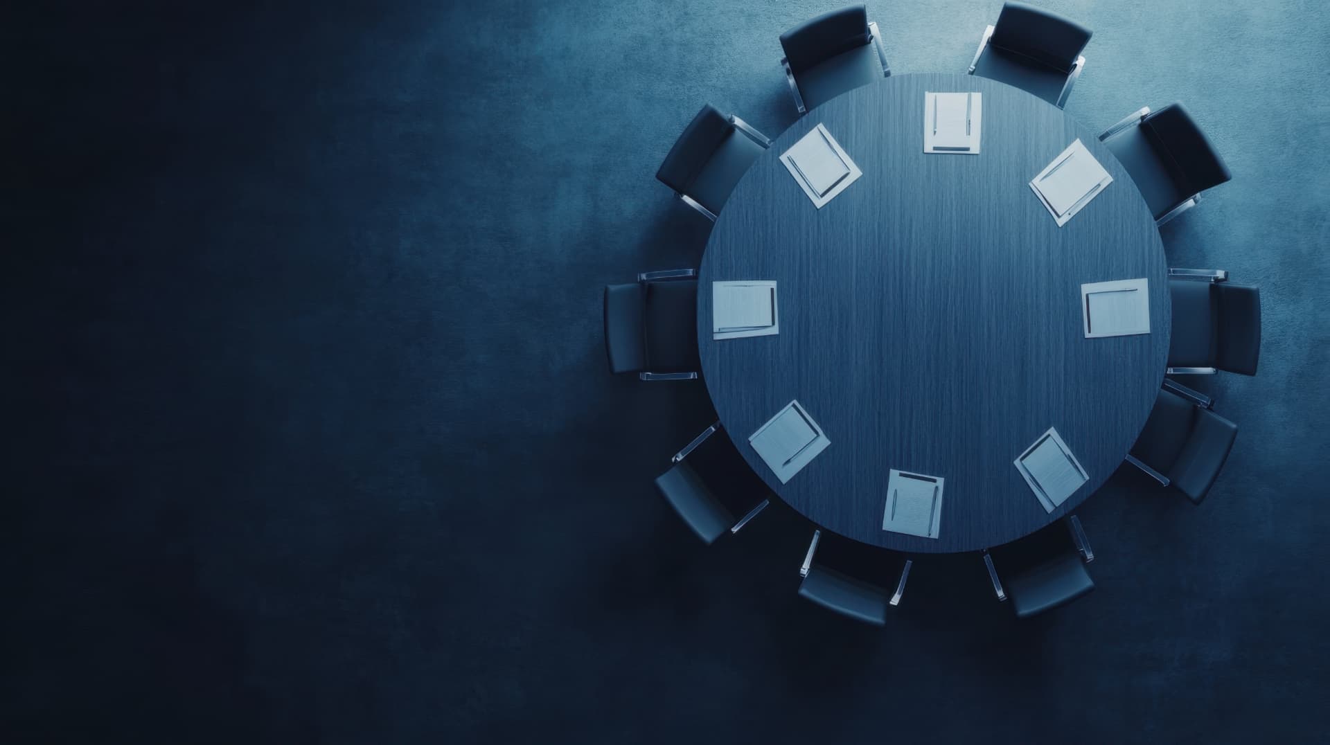 Empty boardroom table prepared for an executive meeting.