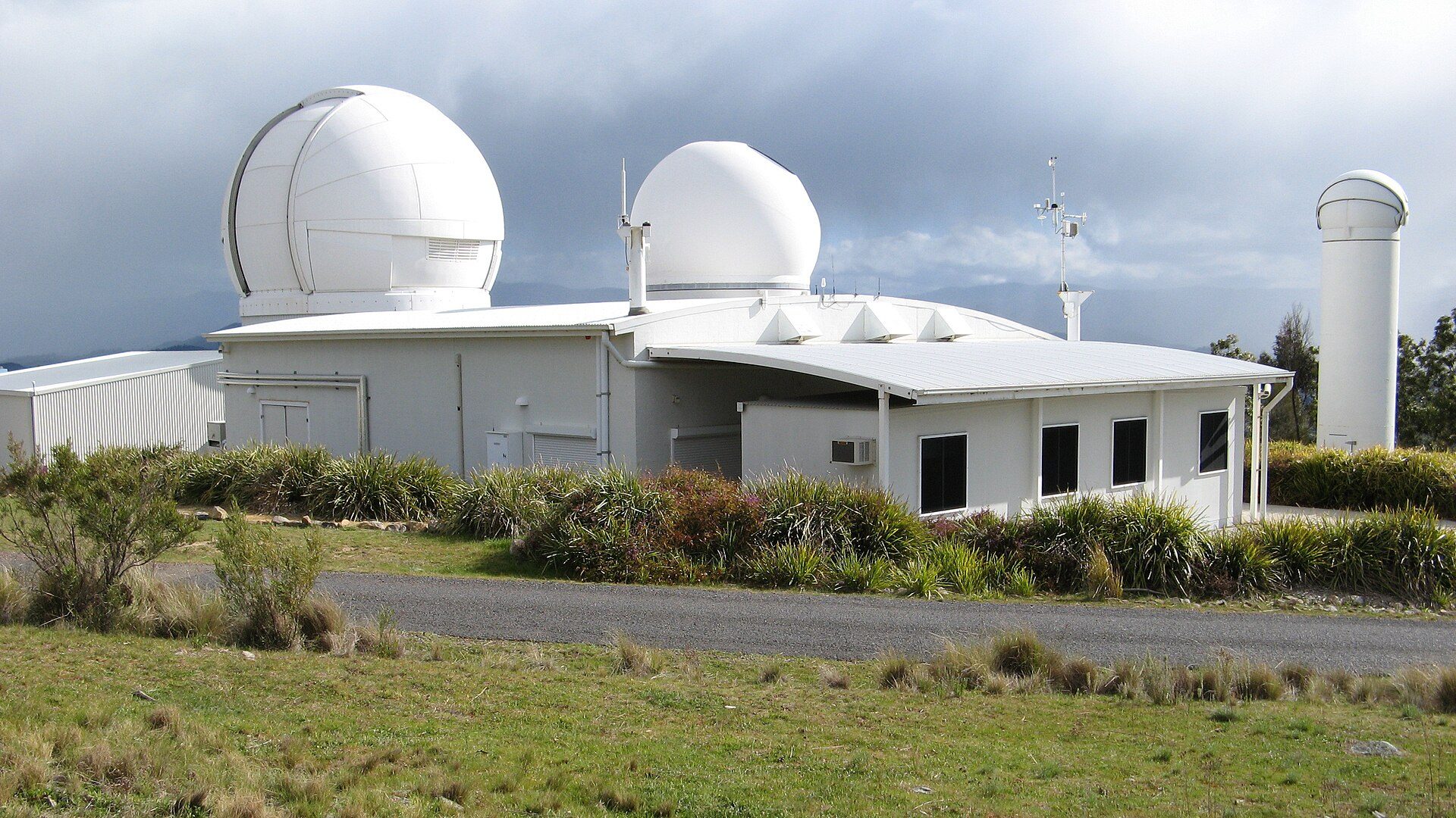 Mount Stromlo satellite laser ranging facility with its white observatory domes near Canberra, Australia