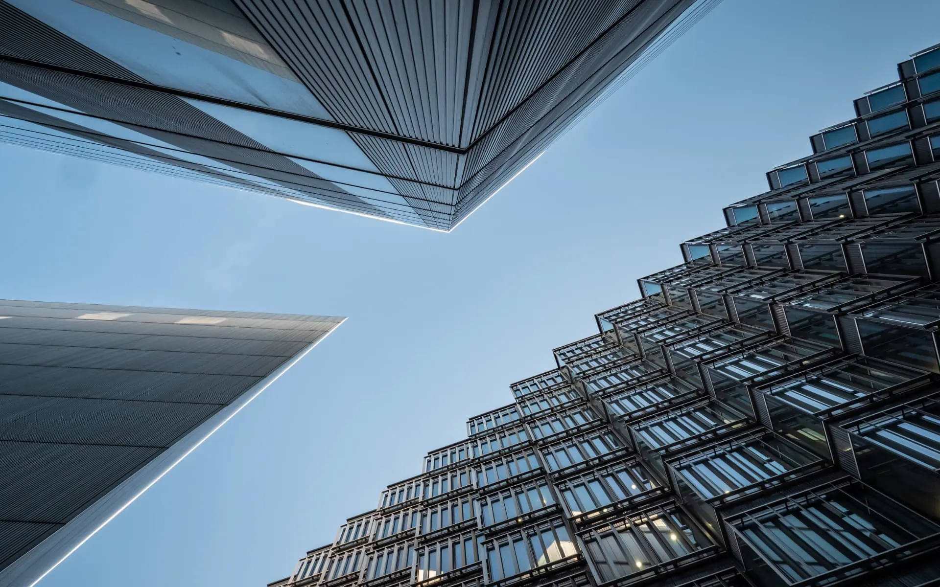 Modern institutional office architecture viewed upward — UK Private Wealth Magazine