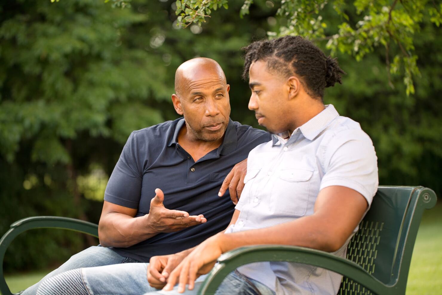Older and younger adults talking together outdoors