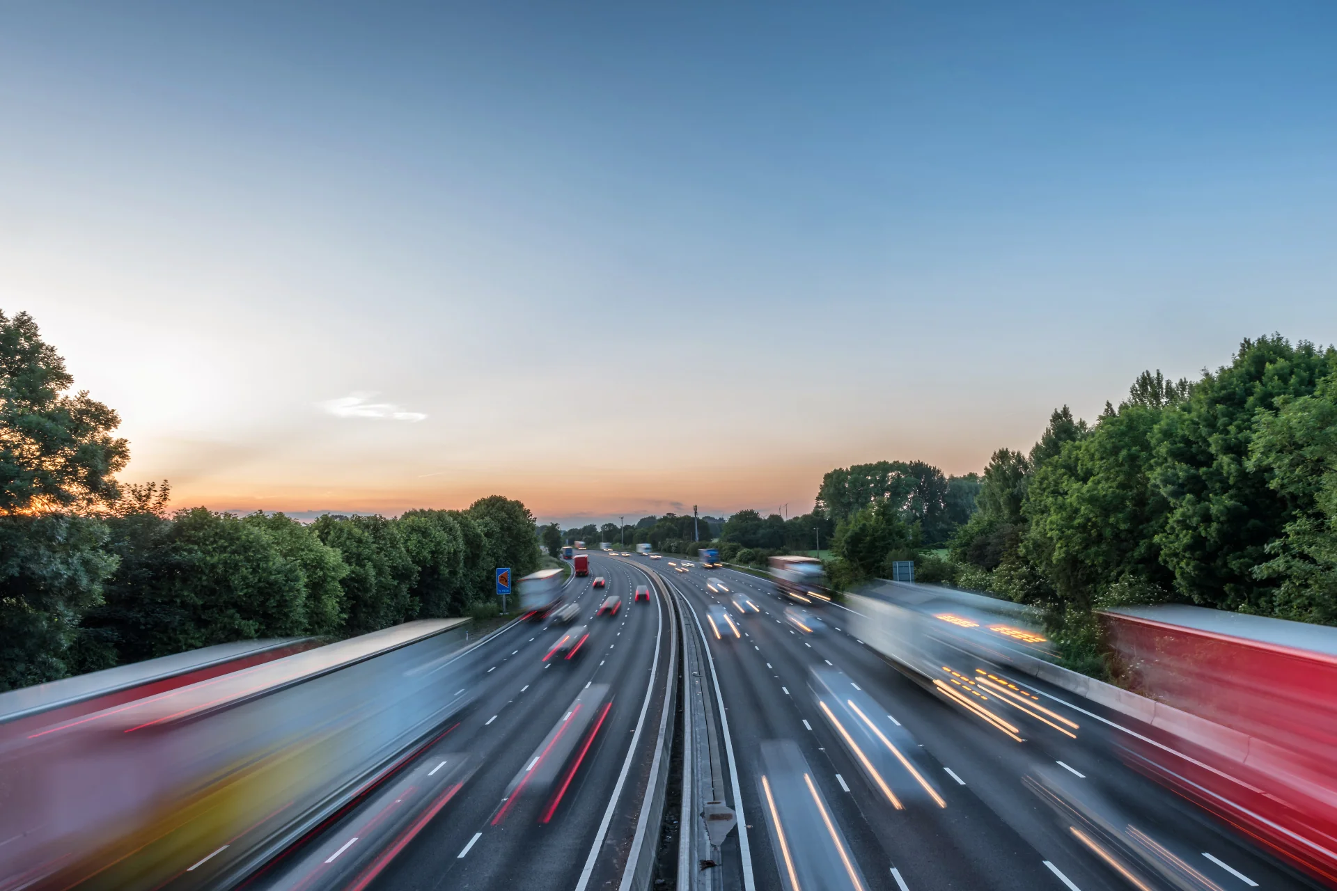 Motorway at dusk with light trails — subscribe to UK Private Wealth Magazine