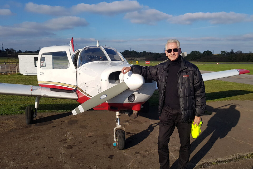 Ian Morley beside an aircraft.
